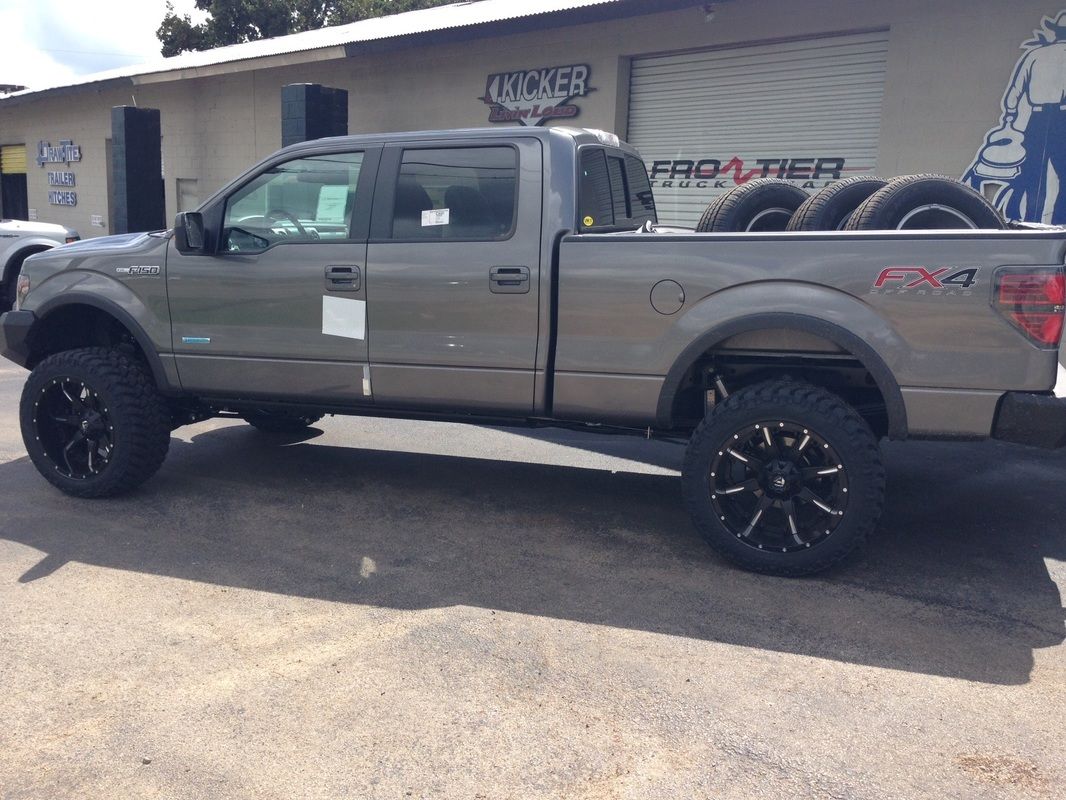 A truck is parked in front of a building that says frontier