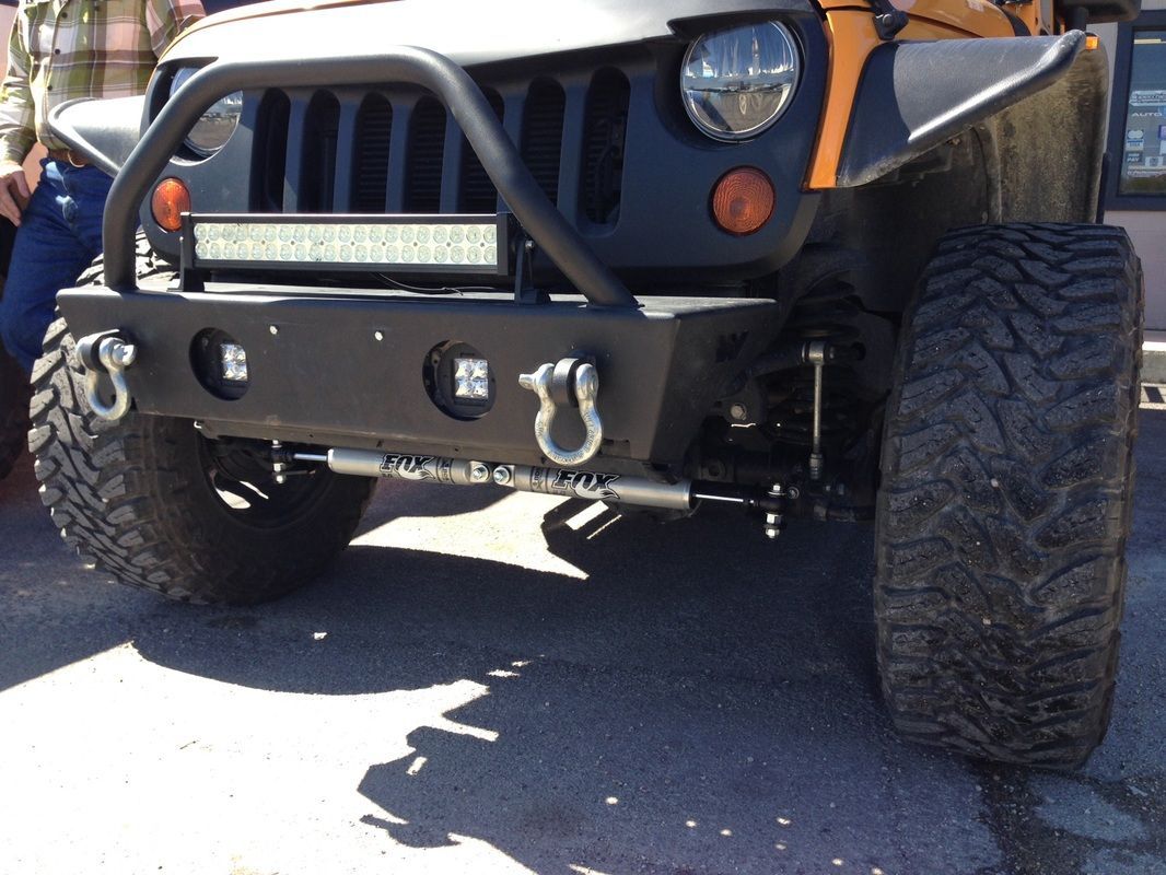 A jeep with a bumper that has hooks on it