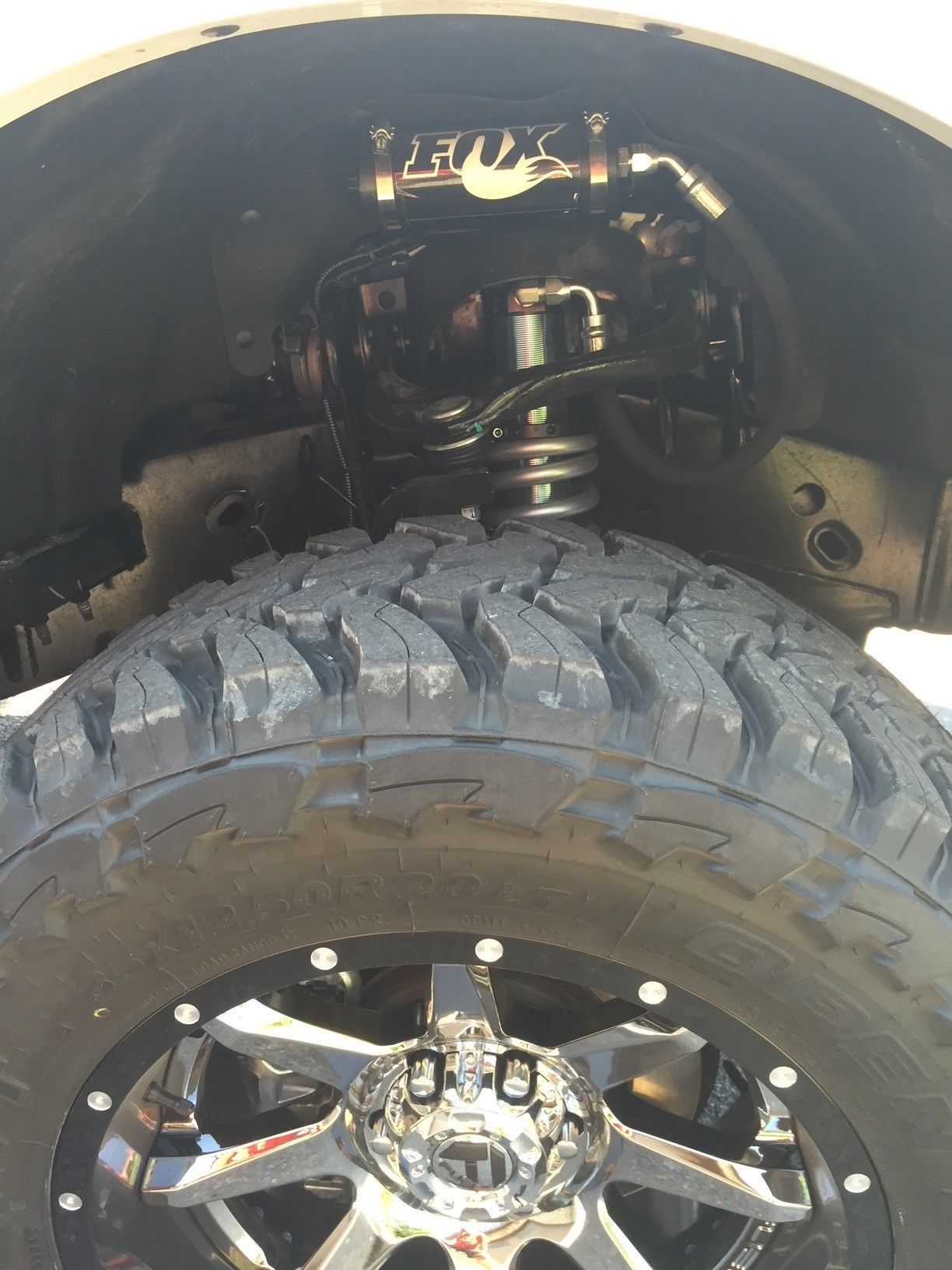 A black truck with a license plate that says ivs-739t is parked in a parking lot.