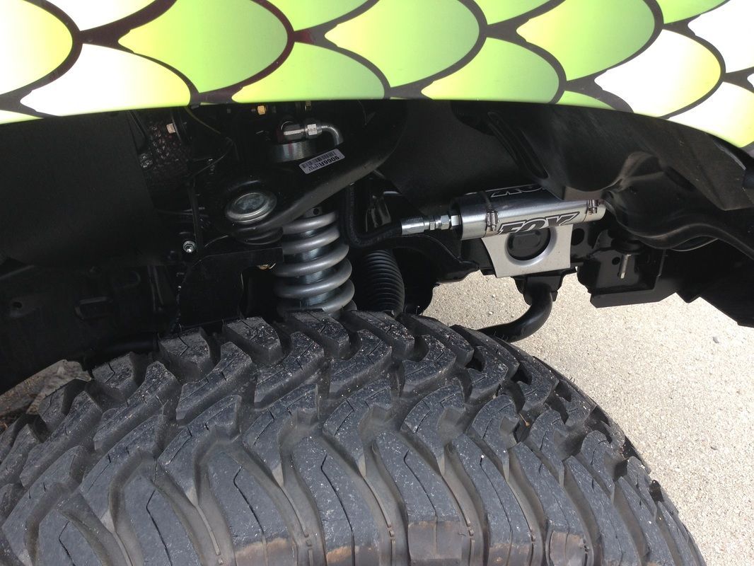 A close up of a tire with a coil spring attached to it