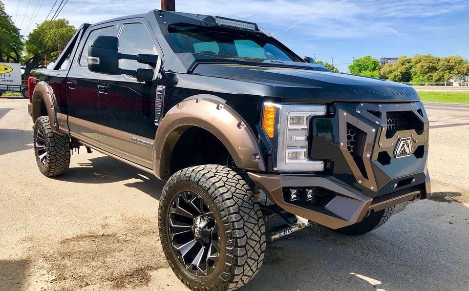 A black pickup truck is parked in a parking lot.
