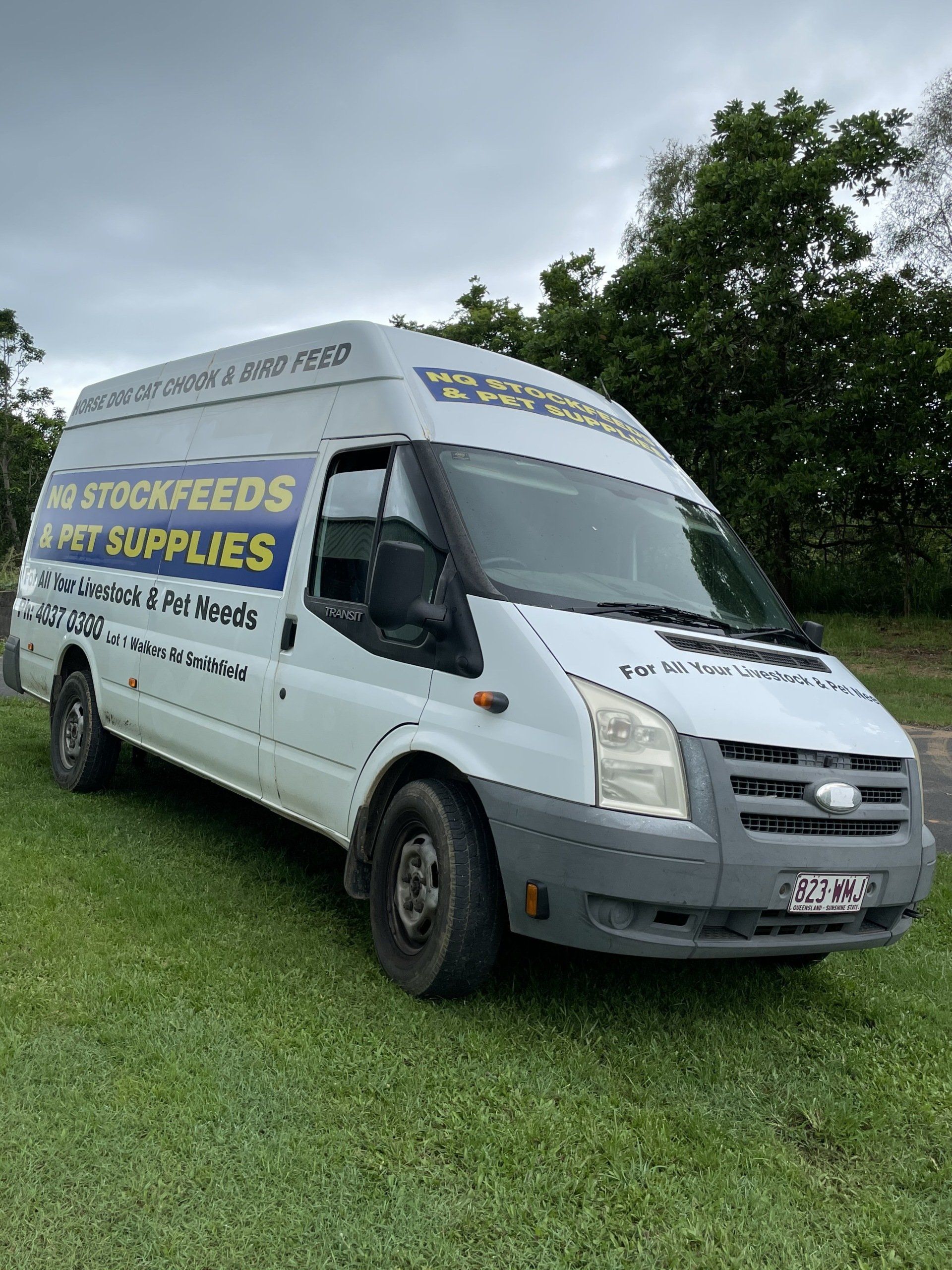 A White Van is Parked in a Grassy Field — NQ Stockfeeds & Farm Supplies in Yorkeys Knob, QLD
