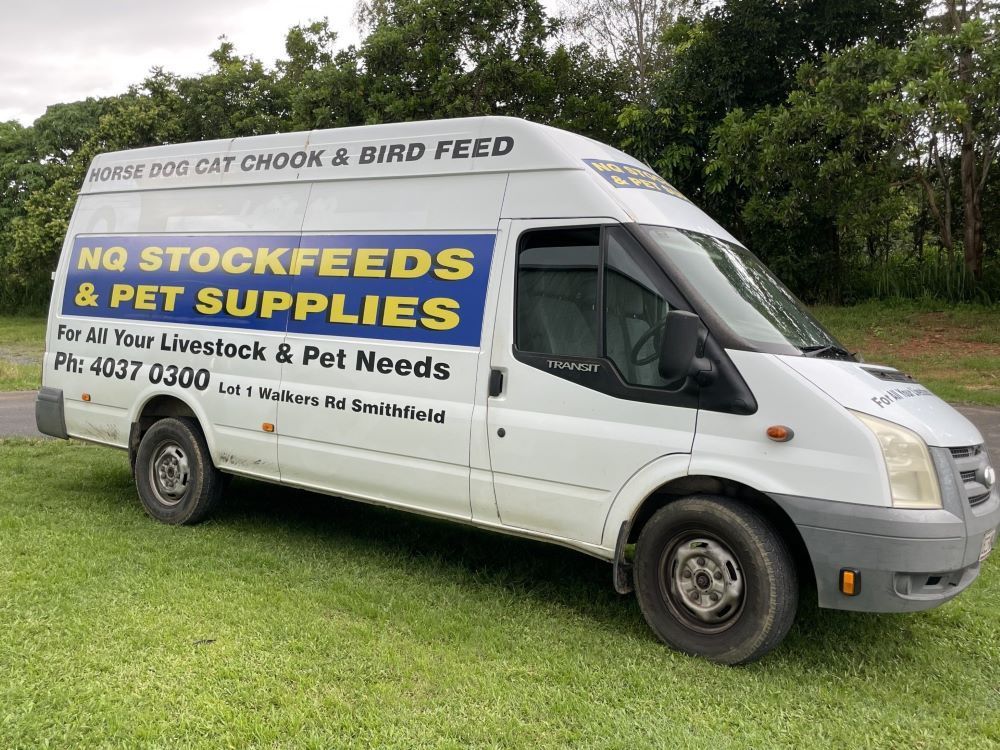 A White Van is Parked in a Grassy Field — NQ Stockfeeds & Farm Supplies in Yorkeys Knob, QLD