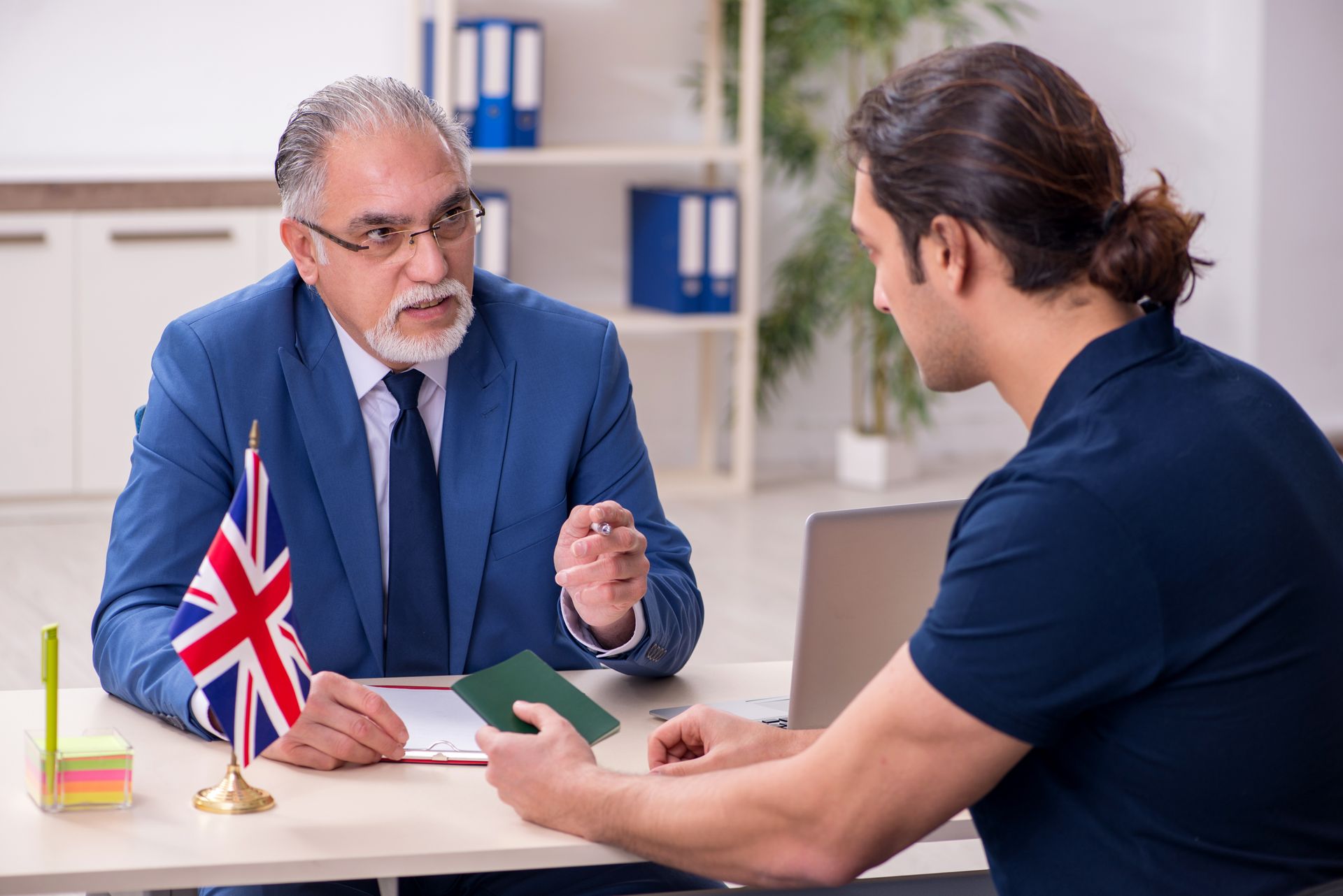 A visa application lawyer advising a client during an immigration meeting.