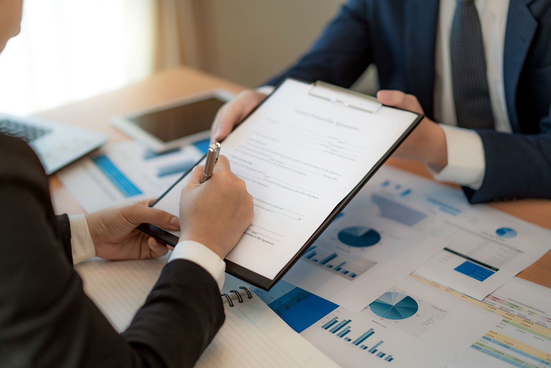 Signing Important Contract In Office - Tampa, FL - Jeeves Law Group