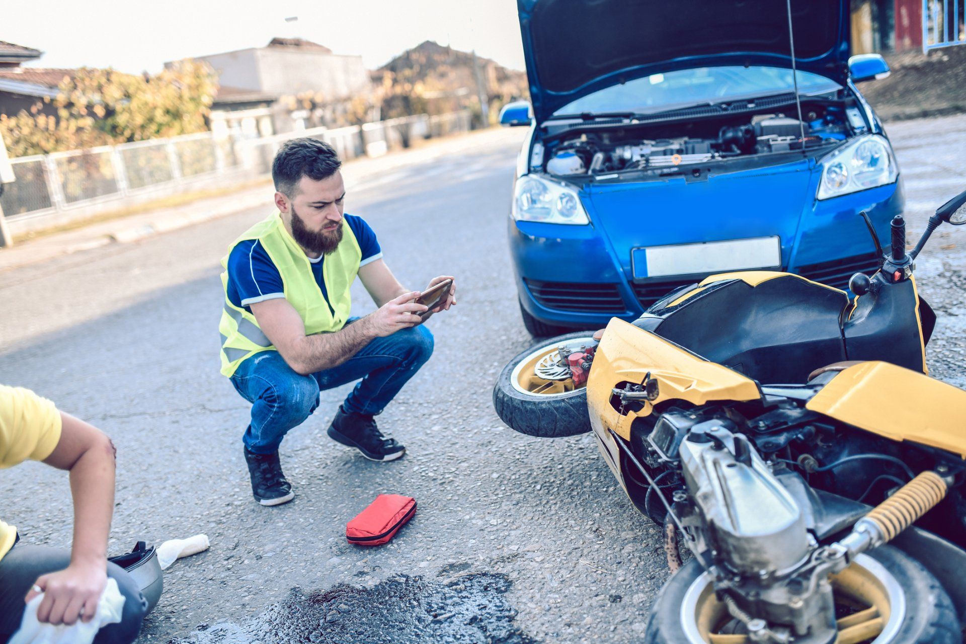 Male Photographing Damage In Traffic Accident - Tampa, FL - Jeeves Law Group