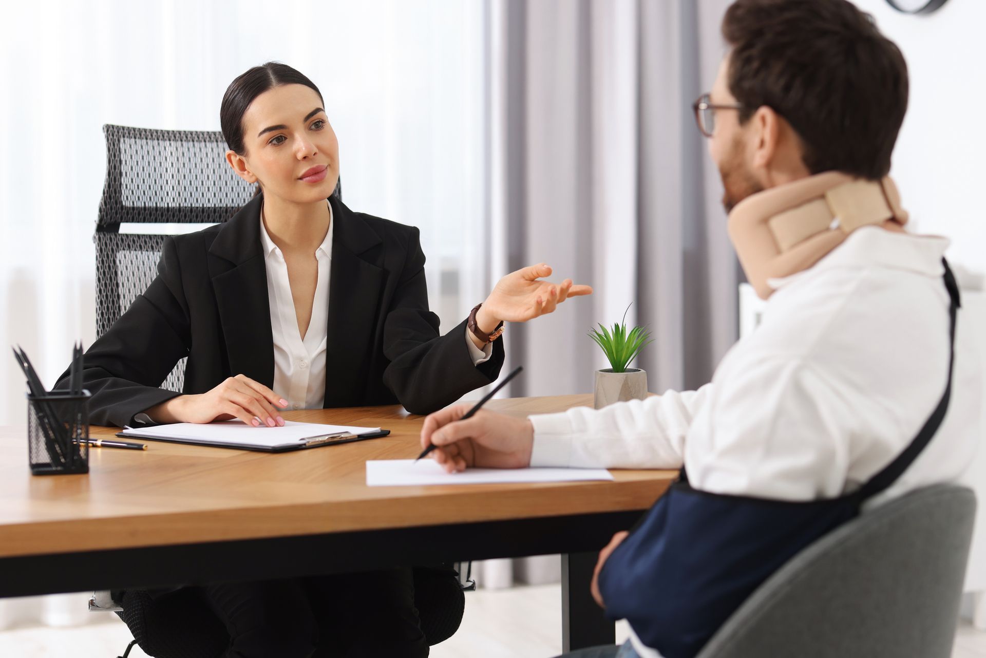 A lawyer is discussing the case with her injured client. A lawyer is discussing the case with her injured client.