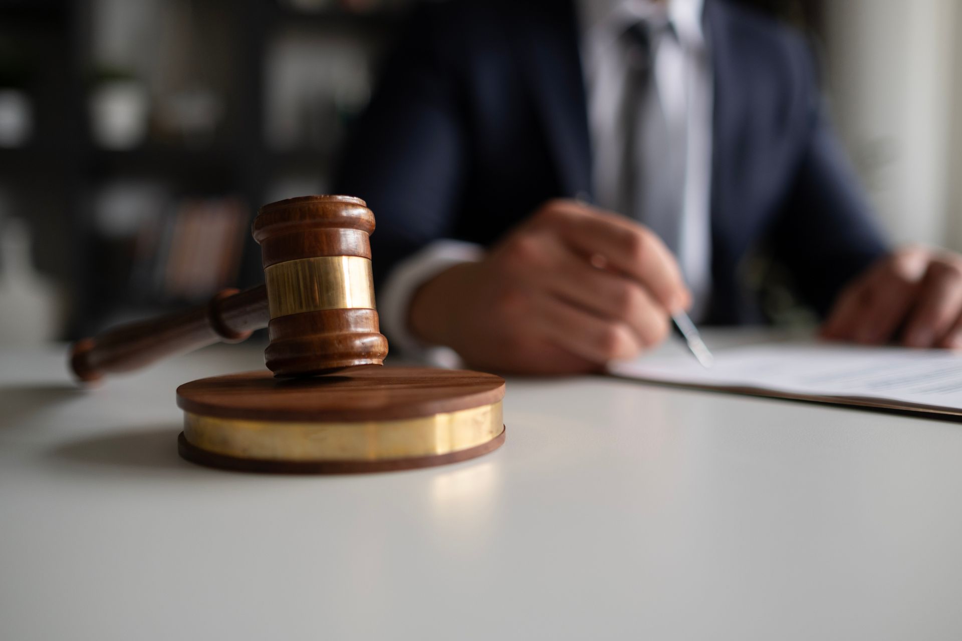 A personal accident attorney, examining legal documents, at his office, with a gavel on his desk.