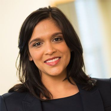 A close up of a woman 's face with a smile on her face.