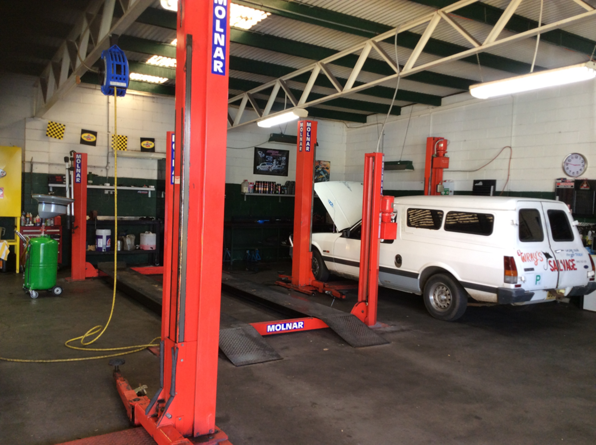 A Mechanic Workshop With A White Car Being Worked On — Fix-It Automotive in Fairy Meadow, NSW