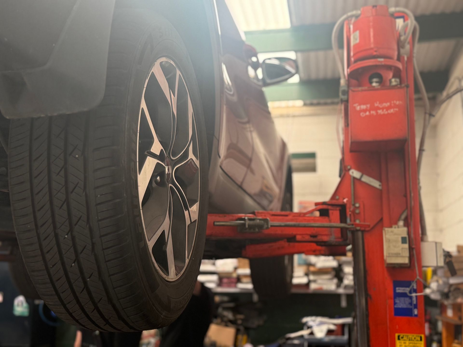 A Man is Installing a Solar Panel on the Roof of a House — Fix-It Automotive in Fairy Meadow, NSW