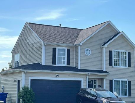 A house with a car parked in front of it.