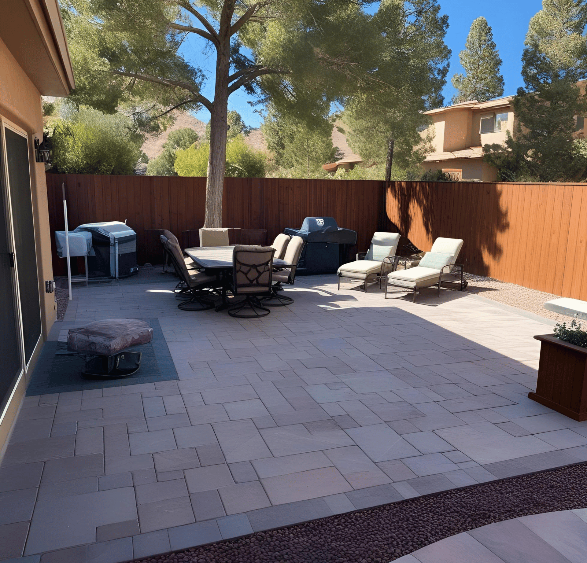 A brick walkway leading to a house designed by All In Hardscape