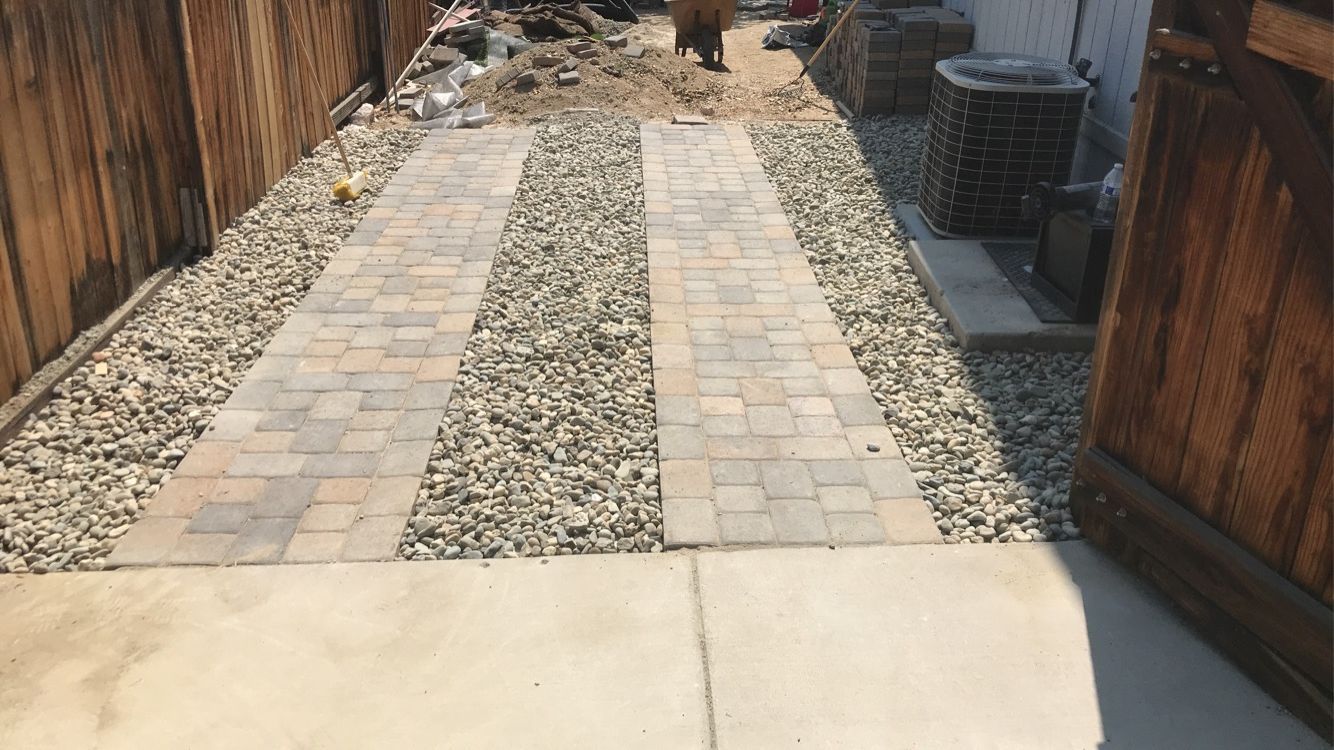 Driveway paver base preparation in Reno NV showing compacted aggregate and edge restraint installation