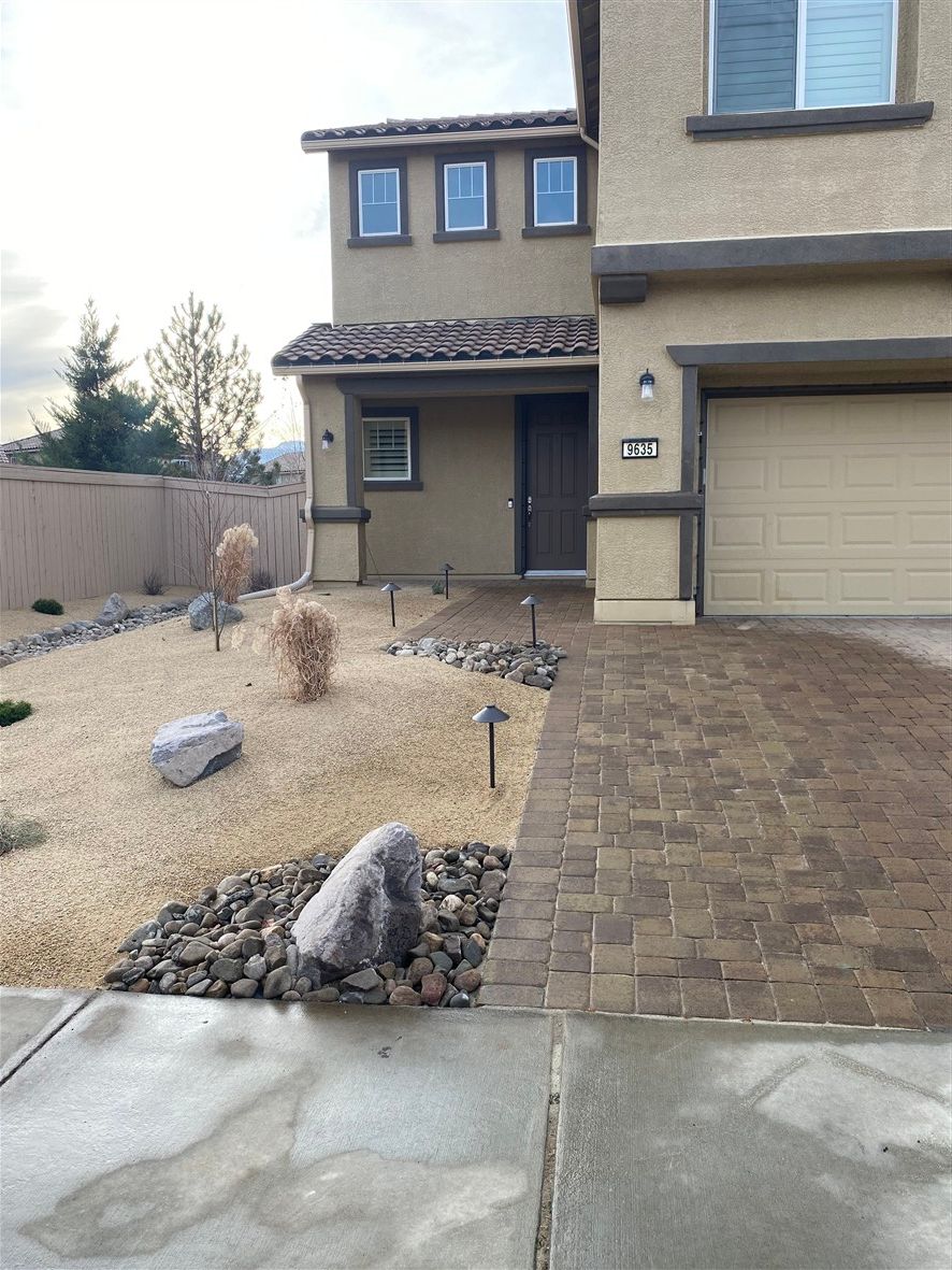 Residential paver driveway installation in Reno NV by All In Hardscape & Landscape with decorative border and front entry walkway