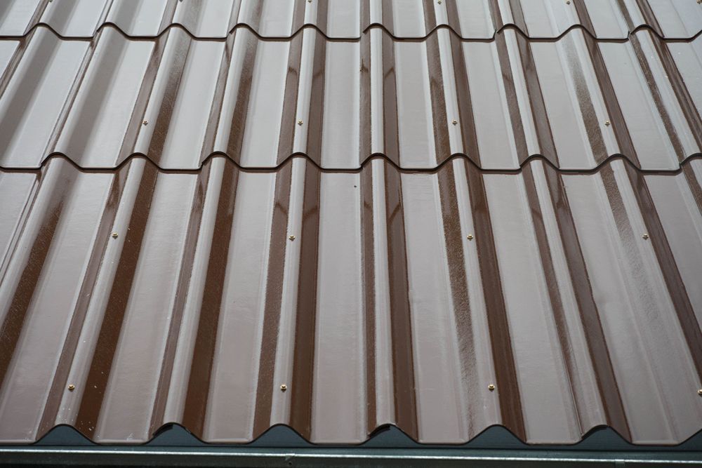 Brown Metal Roof Tiles With a Wavy, Ridged Pattern — Expert Plumbing & Solar Services Bathurst in Orange, NSW