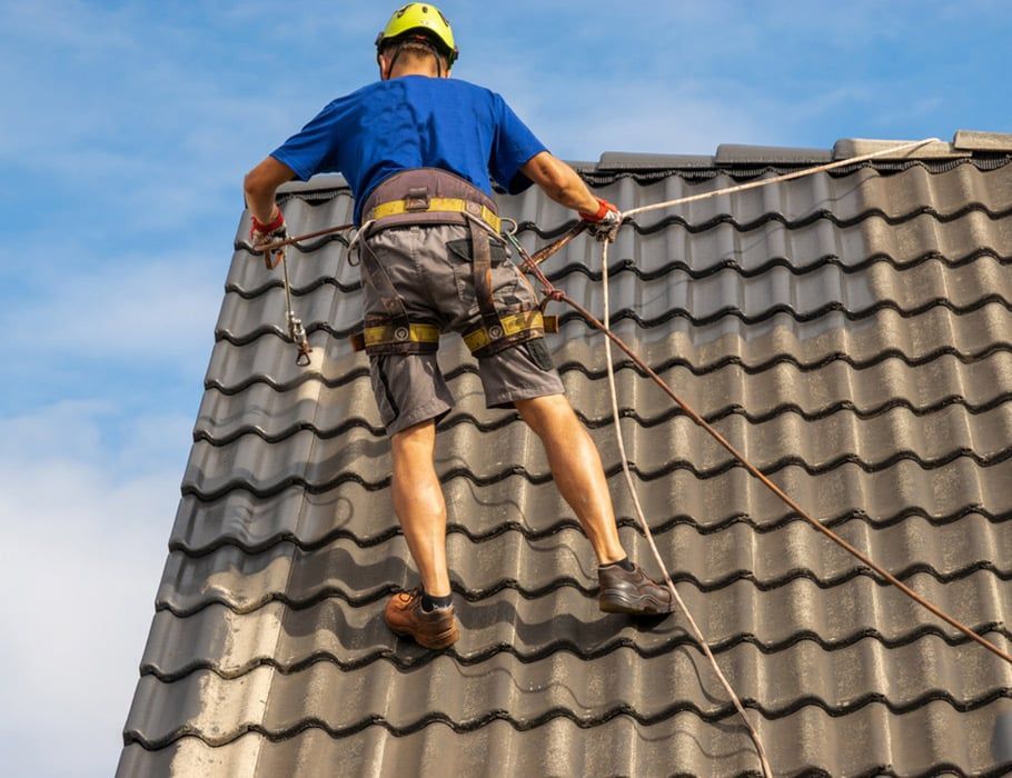 A Worker in a Yellow Safety Helmet and Harness — Expert Plumbing & Solar Services Bathurst in Oberon, NSW