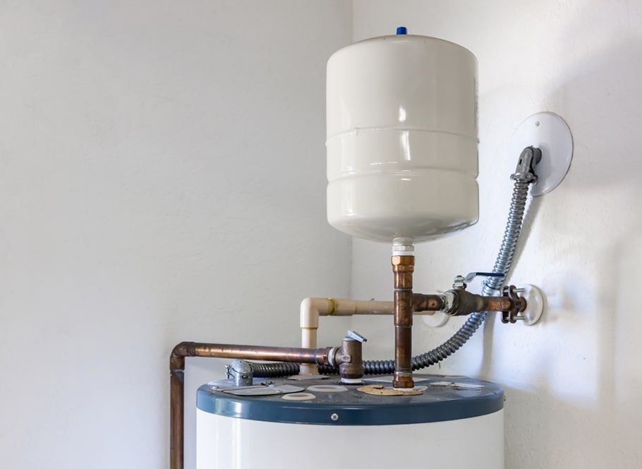 Water Heater With an Expansion Tank Against a White Wall — Expert Plumbing & Solar Services Bathurst in Kelso, NSW