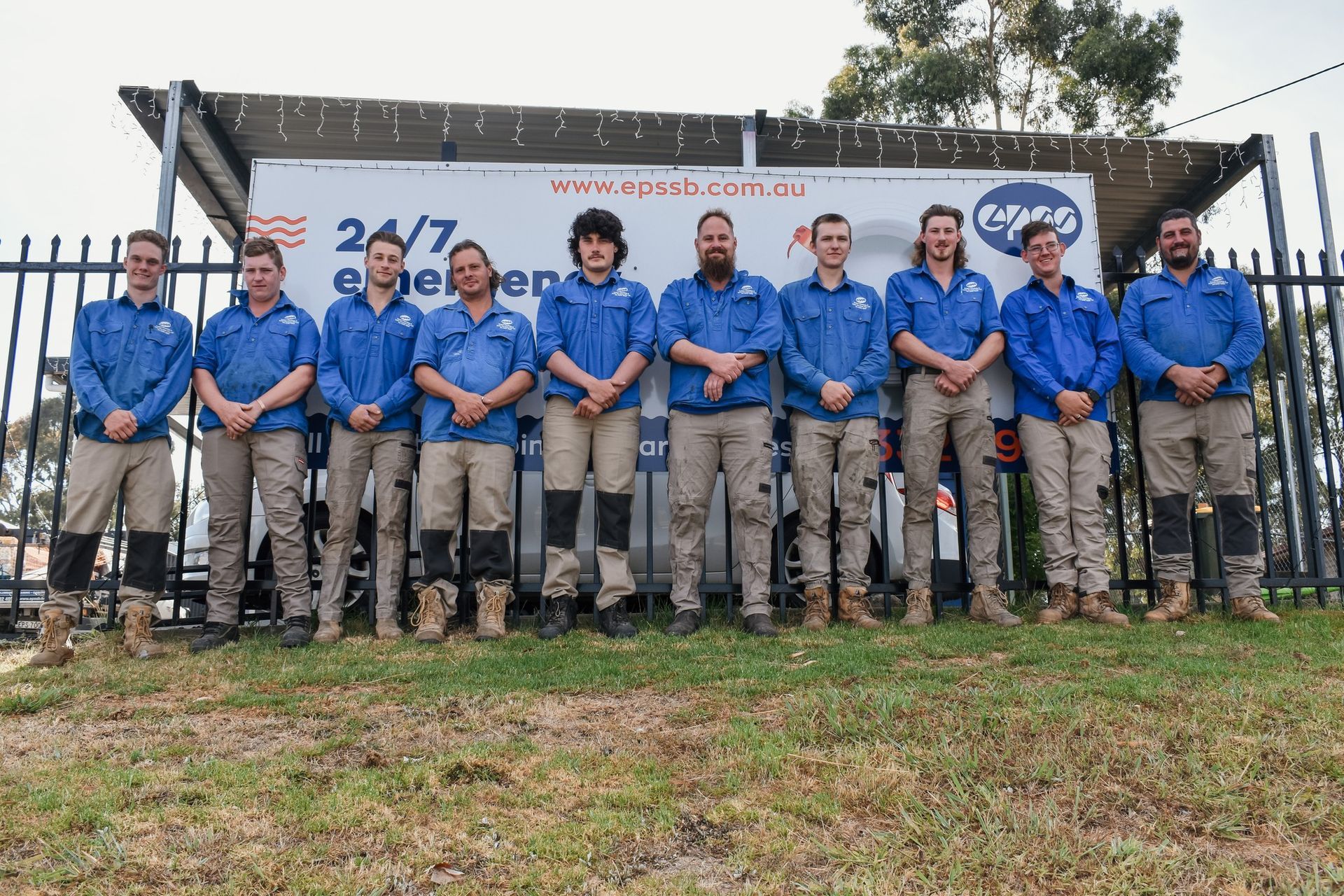 Group of Ten Workers in Uniform Standing Outside a Building — Expert Plumbing & Solar Services Bathurst in Kelso, NSW