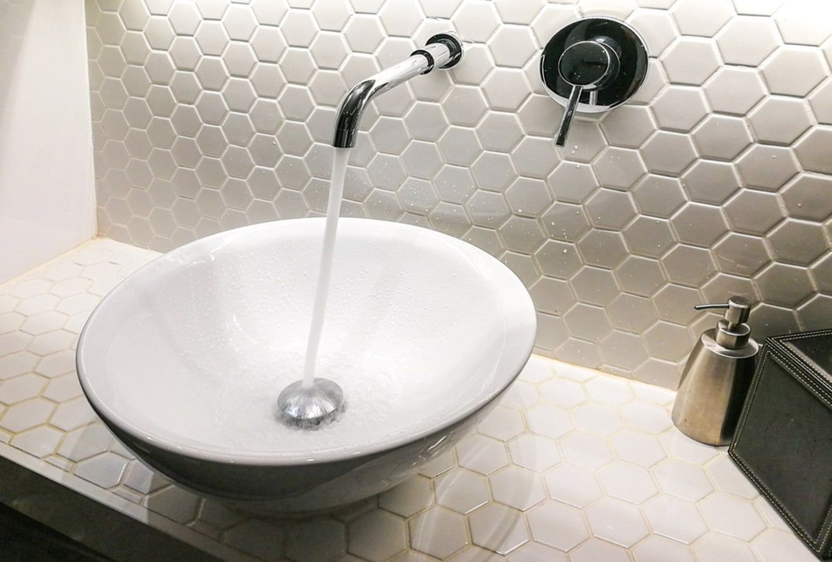 White Sink With Running Water — Expert Plumbing & Solar Services Bathurst in Kelso, NSW