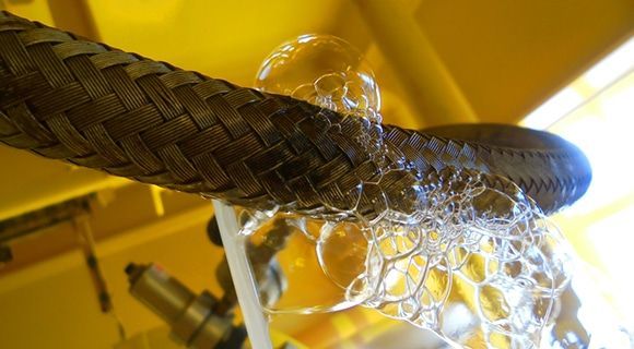 Braided Metal Hose Covered in Soapy Bubbles — Expert Plumbing & Solar Services Bathurst in Kelso, NSW