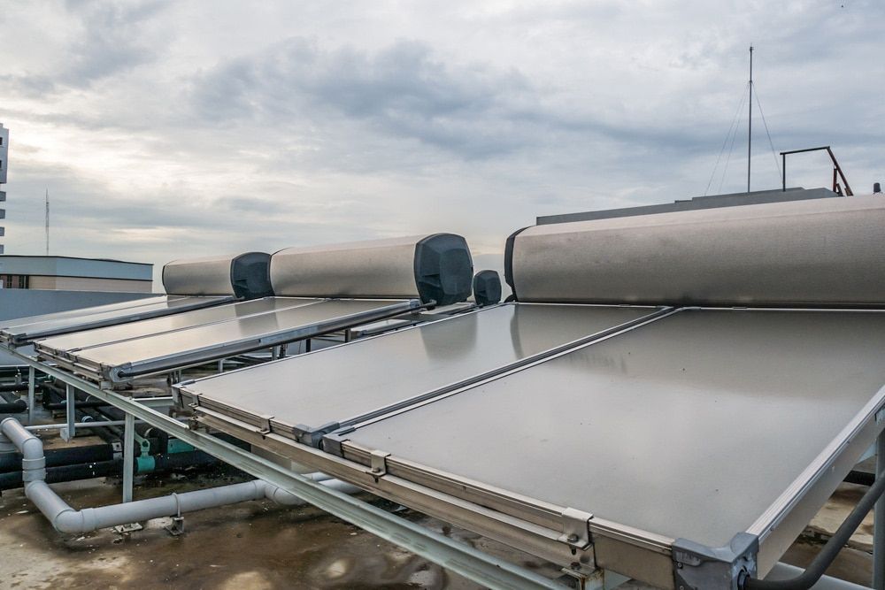 Solar Water Heaters on a Rooftop, With a Cloudy Sky in the Background — Expert Plumbing & Solar Services Bathurst in Kelso, NSW