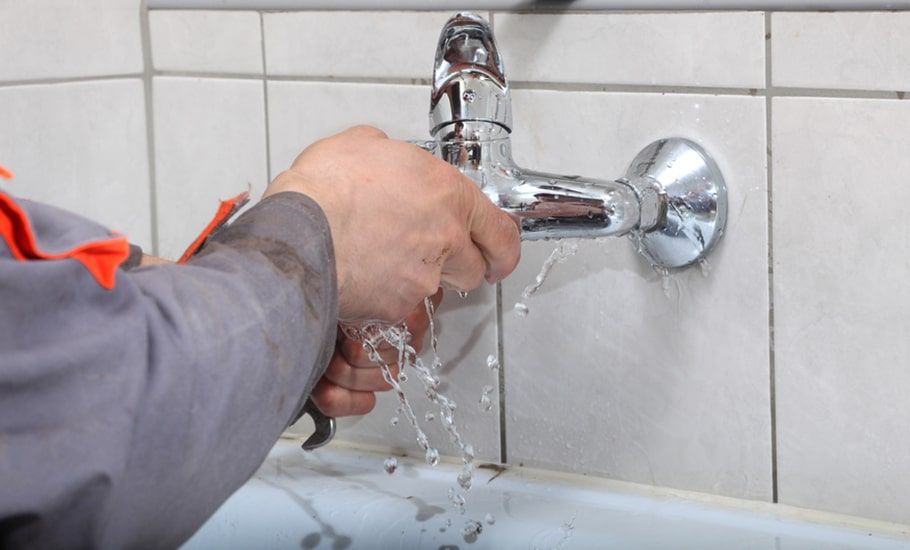 Plumber Repairs a Leaky Faucet, Water Spraying — Expert Plumbing & Solar Services Bathurst in Kelso, NSW