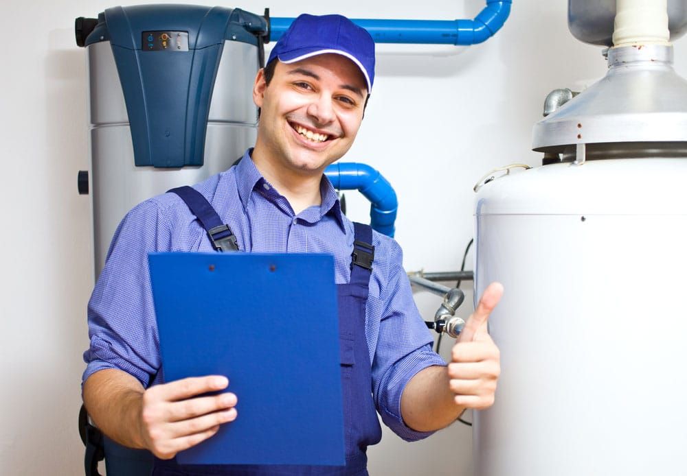 Plumber in Blue Uniform Smiles, Holding Clipboard — Expert Plumbing & Solar Services Bathurst in Kelso, NSW