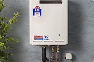 A White Rinnai Infinity 32 Gas Water Heater Mounted — Expert Plumbing & Solar Services Bathurst in Kelso, NSW