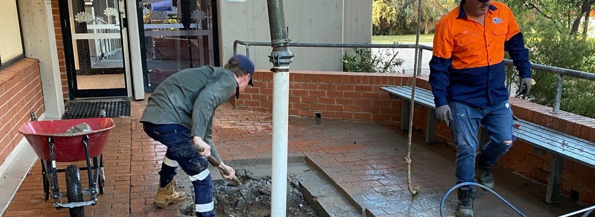 Two Workers Repairing a Brick Patio — Expert Plumbing & Solar Services Bathurst in Kelso, NSW