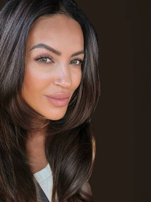 A woman is holding a camera in front of her face, by Jelena's Photo.