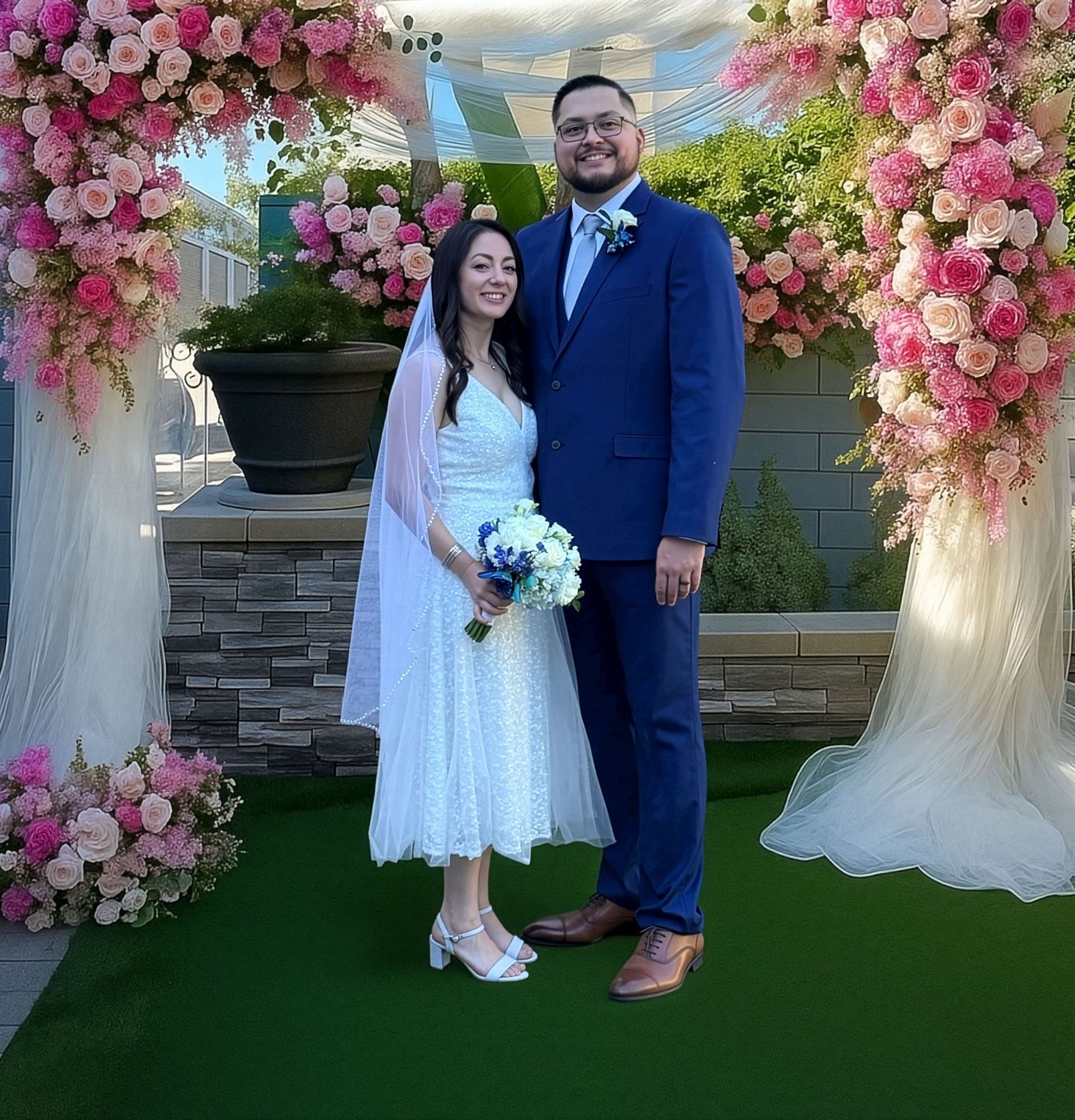 Wedding portrait of a young couple with beautiful floral arch in Irvine, CA by Jelena's Photo.