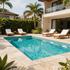 Modern villa patio with turquoise swimming pool, white lounge chairs, and palm trees