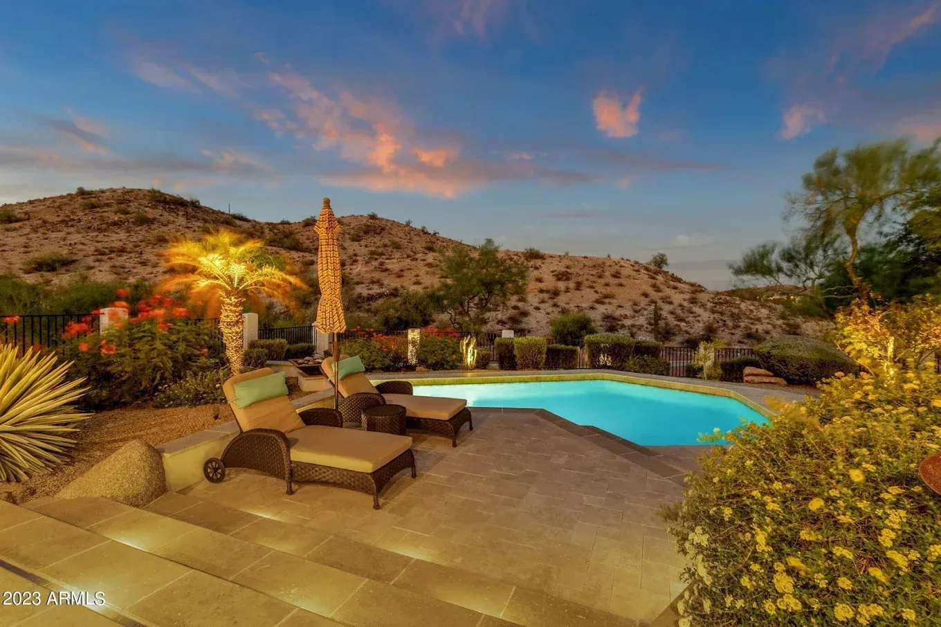 A white roofing company truck is parked in a grassy field.