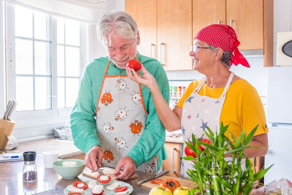 couple of two happy seniors having fun and cooking