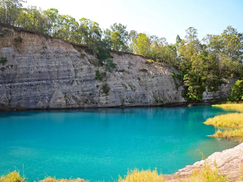 A Large Body of Water Surrounded by Trees and Rocks — O'Grady's Transport & Removals in Lismore, NSW