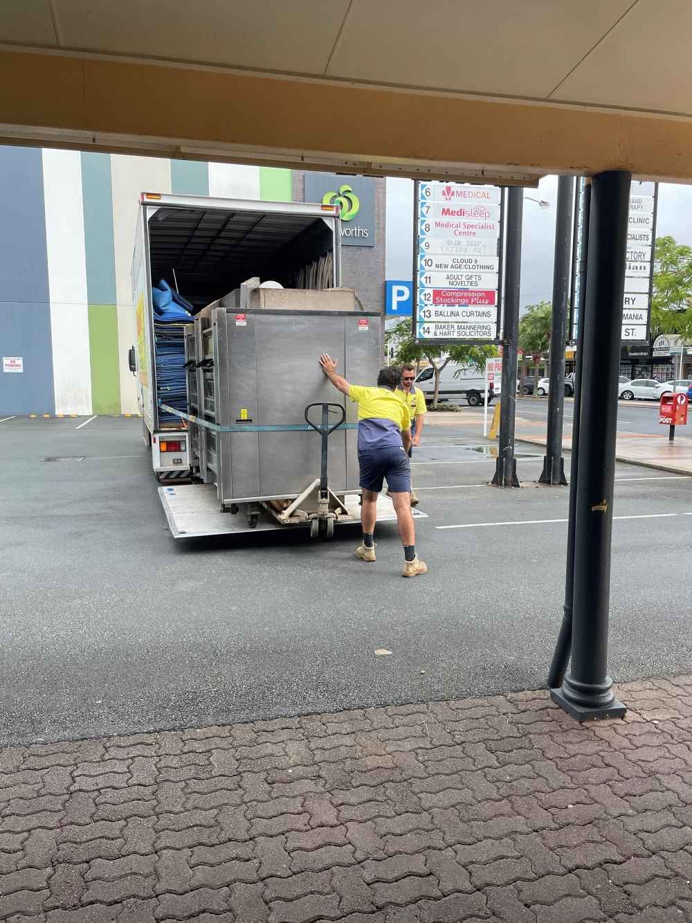 Two Men Are Loading Commercial Oven Into a Van — O'Grady's Transport & Removals in Ballina, NSW