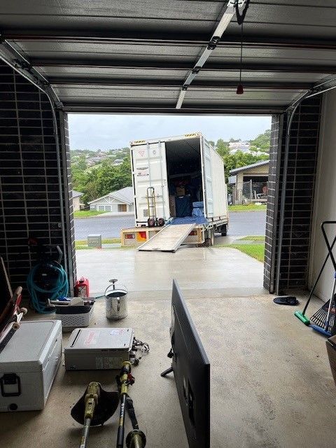 A Truck is Parked in a Garage Next to a Television — O'Grady's Transport & Removals in Hervey Bay, NSW