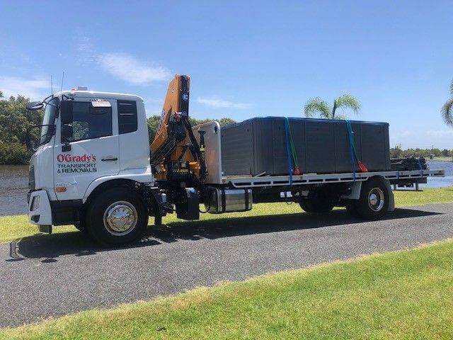 A Large Truck With a Crane on the Back is Parked on the Side of the Road — O'Grady's Transport & Removals in Ballina, NSW