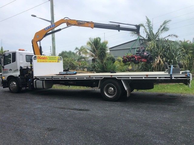 A Yellow Truck With a Crane Attached to It — O'Grady's Transport & Removals in Alstonville, NSW