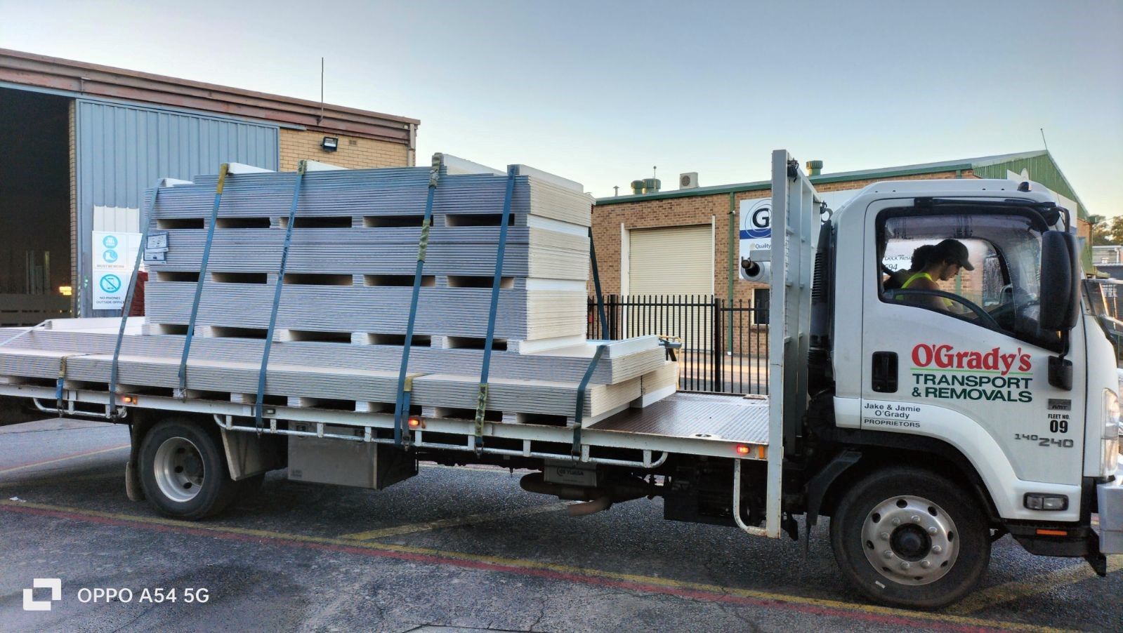 A White Truck is Carrying a Stack of Pallets — O'Grady's Transport & Removals in Alstonville, NSW
