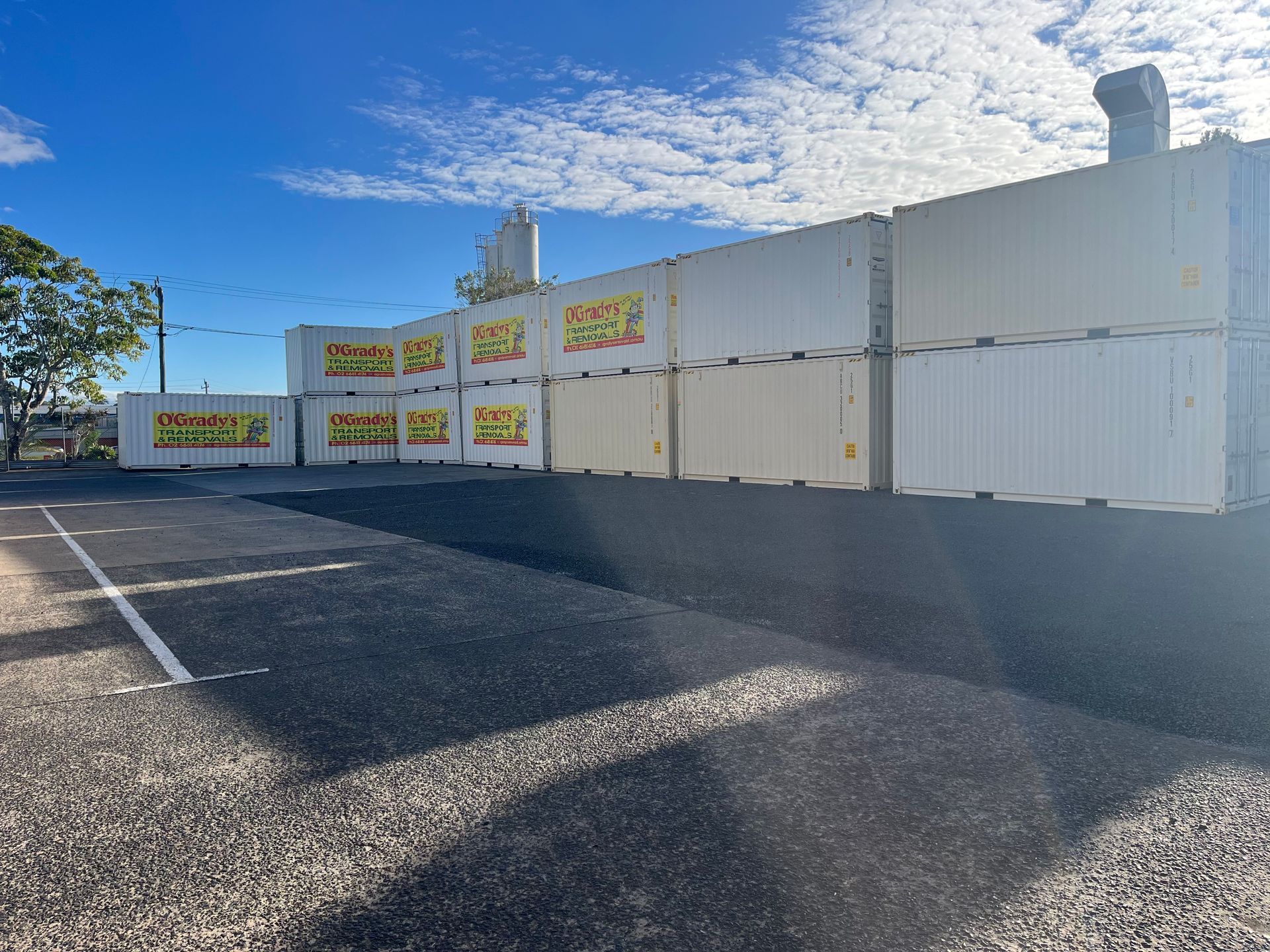 A Row of Shipping Containers Are Lined Up in a Parking Lot — O'Grady's Transport & Removals in West Ballina, NSW