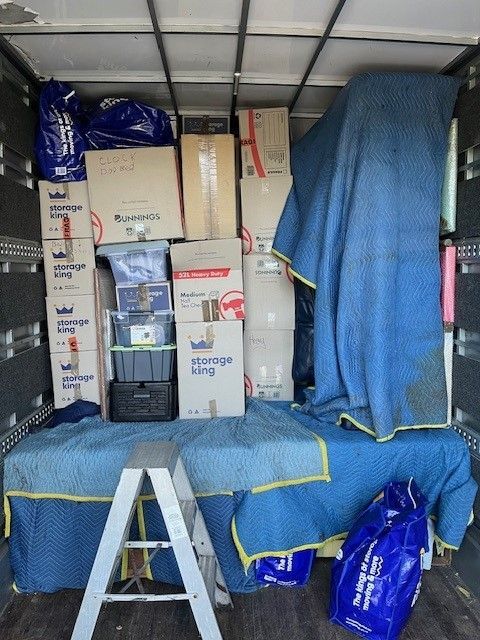 A Ladder is in the Back of a Moving Truck Filled With Boxes and Bags — O'Grady's Transport & Removals in Ballina, NSW