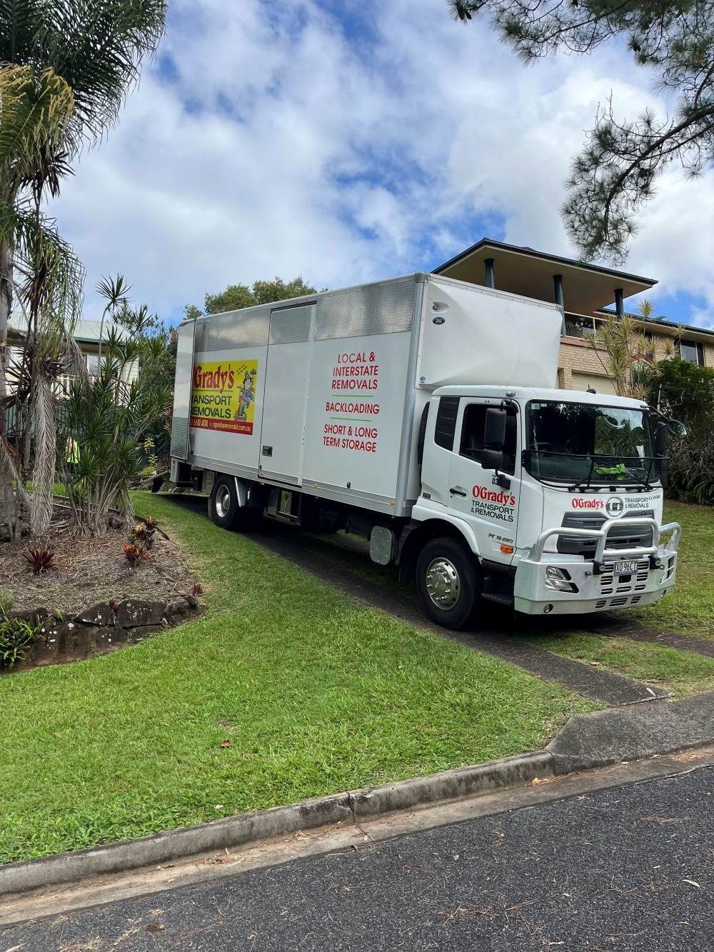 A White Truck With a Forklift Attached to It is Parked — O'Grady's Transport & Removals in Brisbane, NSW