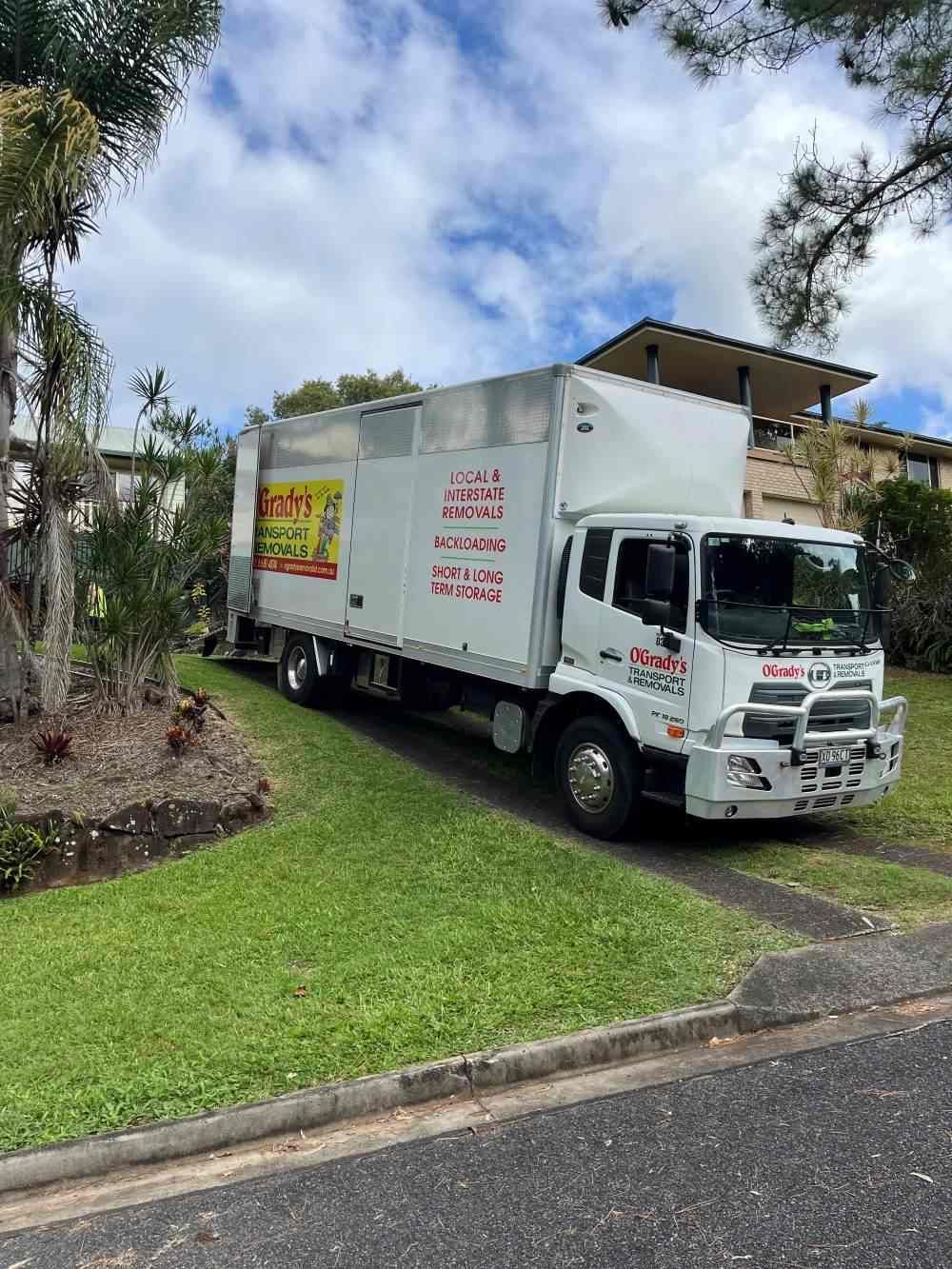 A White Truck With a Stack of Pallets on the Back — O'Grady's Transport & Removals in Hervey Bay, NSW
