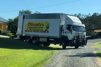 A Moving Truck is Parked on the Side of a Dirt Road  — O'Grady's Transport & Removals in Alstonville, NSW