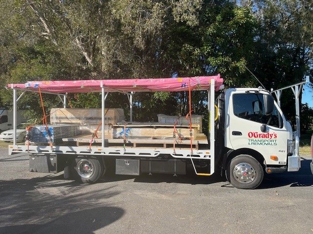 A White Moving Truck is Parked on the Side of the Road — O'Grady's Transport & Removals in Ballina, NSW
