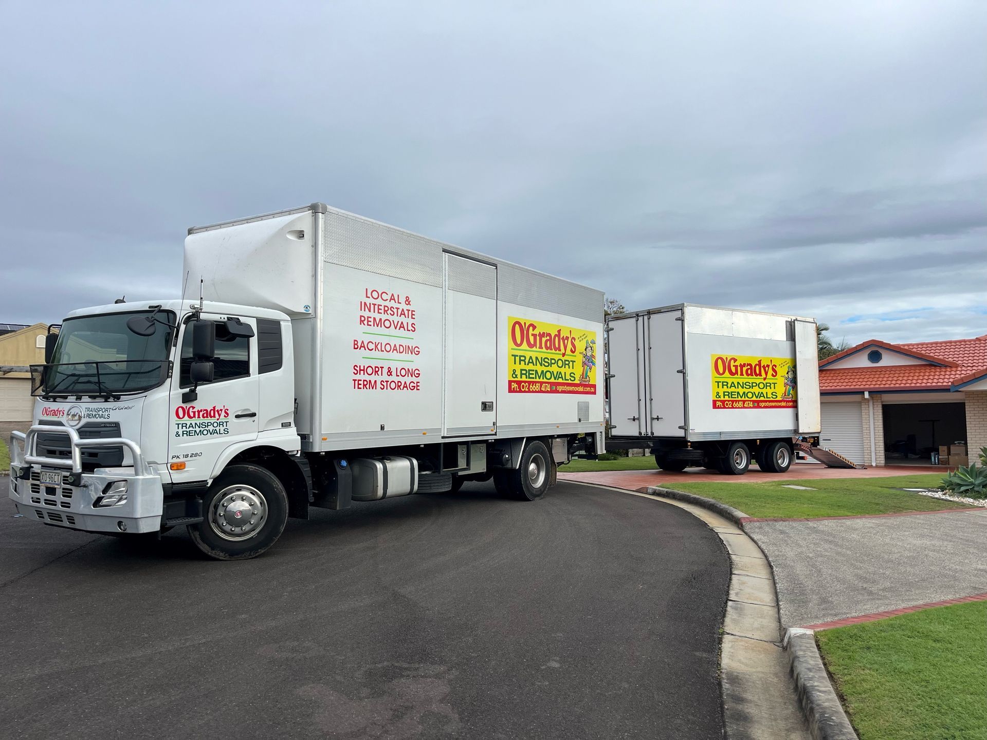 A Moving Truck is Parked in Front of a House — O'Grady's Transport & Removals in Newcastle, NSW