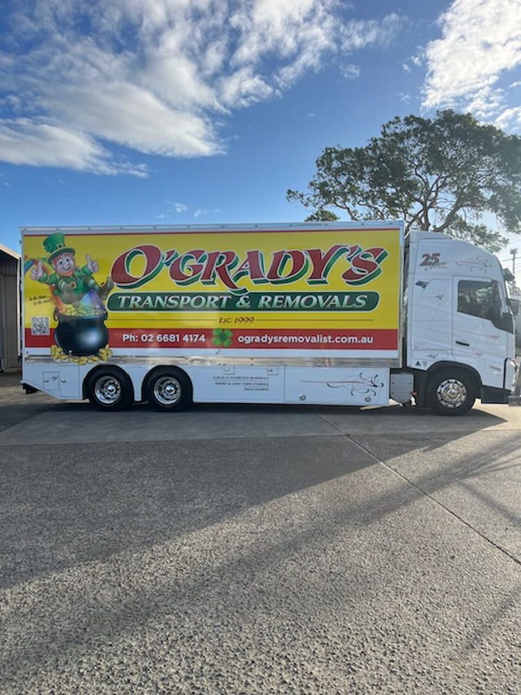 A Row of Shipping Containers Are Lined Up in a Parking Lot — O'Grady's Transport & Removals in West Ballina, NSW