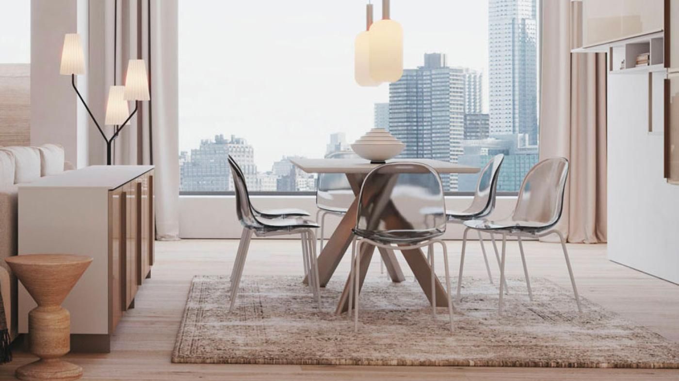 Una sala da pranzo con tavolo e sedie di fronte a una grande finestra.